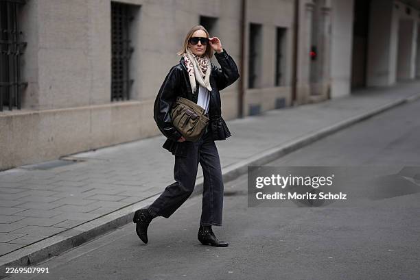 Marlies Pia Pfeifhofer is seen wearing a black leather "Rubik" jacket with a pointed collar and front button closure and flared hem from Agolde; a...