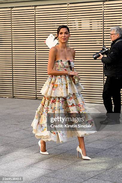 Eugenia Rodriguez wearing a Zimmermann dress, gold Chanel bag and white Christian Louboutin stilettos outside the Zimmermann show during Day Eight of...