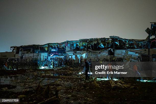 Emergency crews inspect damage after an Iranian ballistic missile struck an industrial area on April 2, 2026 in Petah Tikva, Israel. Iran has...