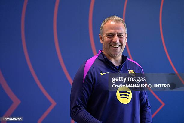 Barcelona's German coach Hans-Dieter Flick smiles as he leaves after a press conference on the eve of their UEFA Champions League quarter final...