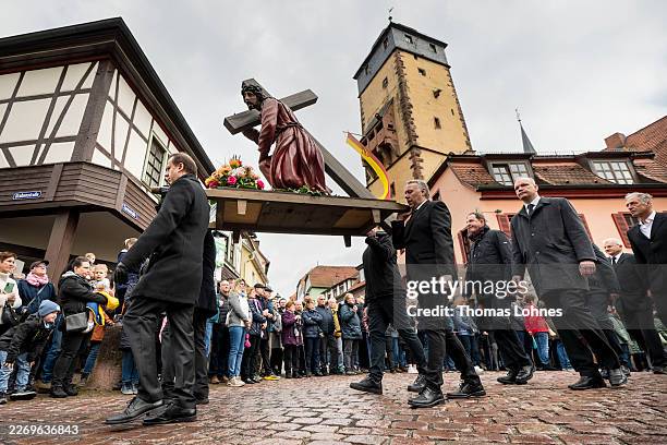 Members of various craft guilds carry a wooden statue of Jesus during the annual Good Friday procession on April 03, 2026 in Lohr am Main, Germany....
