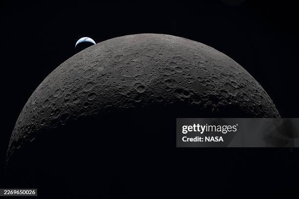In this handout image provided by NASA, Earth sets at 6:41 p.m. EDT, April 6 over the Moon’s curved limb in this photo captured by the Artemis II...