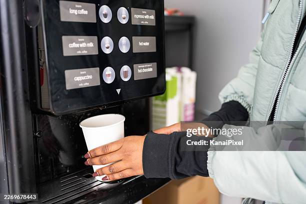 person getting coffee from self-service machine - coffee vending machine stock pictures, royalty-free photos & images