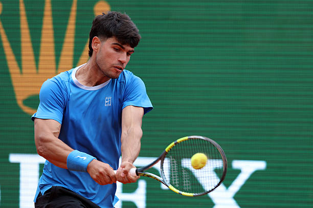 Carlos Alcaraz of Spain plays a backhand during his match against Sebastian Baez of Argentina during day Three of the Rolex Monte-Carlo Masters at...