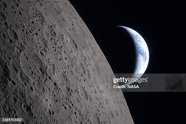 In this handout image provided by NASA, as the Artemis II crew came close to passing behind the Moon and experiencing a planned loss of signal, they...