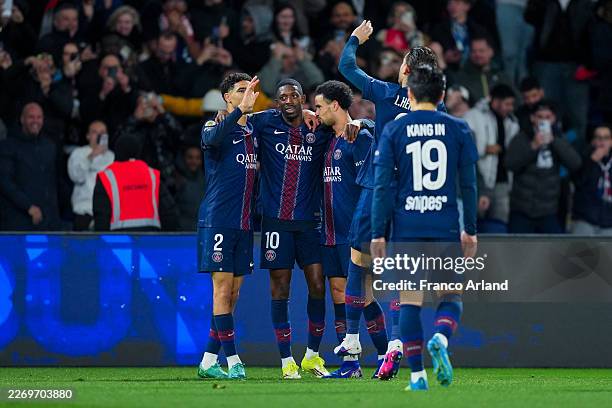 Ousmane Dembele of PSG celebrates after scoring his team's first goal Achraf Hakimi of PSG during the Ligue 1 McDonald's match between Paris...