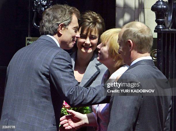 British Prime Minister Tony Blair kisses Ludmila , wife of Russian President Vladimir Putin , as Cherry looks at them during the meeting at Downing...