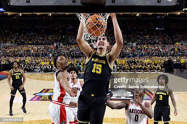 Aday Mara of the Michigan Wolverines dunks the ball in the first half against the Arizona Wildcats in the Final Four of the 2026 NCAA Men's...