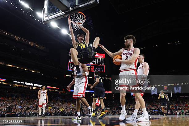 Aday Mara of the Michigan Wolverines dunks the ball against the Arizona Wildcats during the second half in the Final Four of the 2026 NCAA Men's...