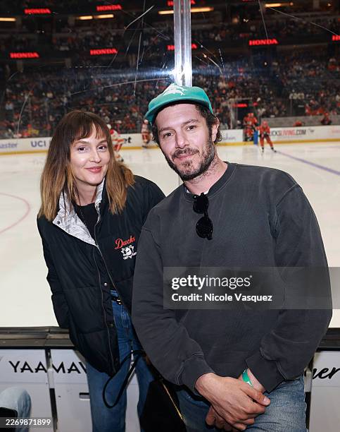 Leighton Meester and Adam Brody attend the game between the Anaheim Ducks and Calgary Flames at Honda Center on April 04, 2026 in Anaheim, California.