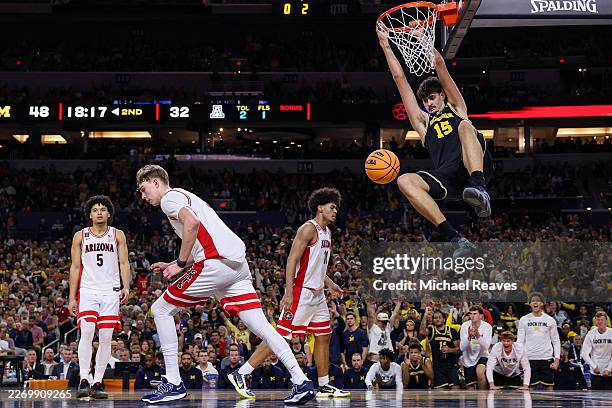 Aday Mara of the Michigan Wolverines dunks the ball against the Arizona Wildcats during the second half in the Final Four of the 2026 NCAA Men's...