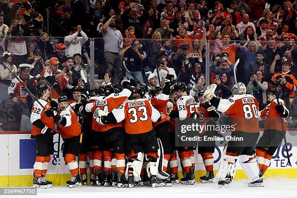 The Philadelphia Flyers celebrate a goal by Porter Martone during overtime against the Boston Bruins for a 2-1 win at Xfinity Mobile Arena on April...