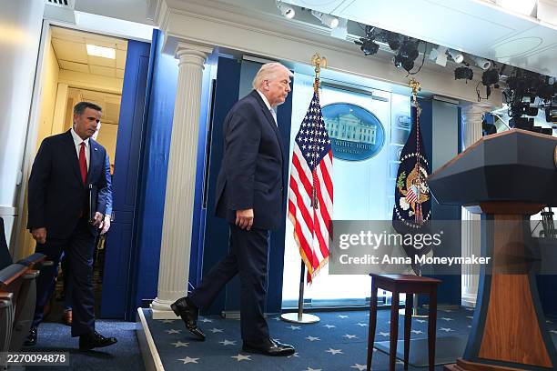 President Donald Trump and Central Intelligence Agency Director John Ratcliffe arrive for a news conference in James S. Brady Press Briefing Room of...