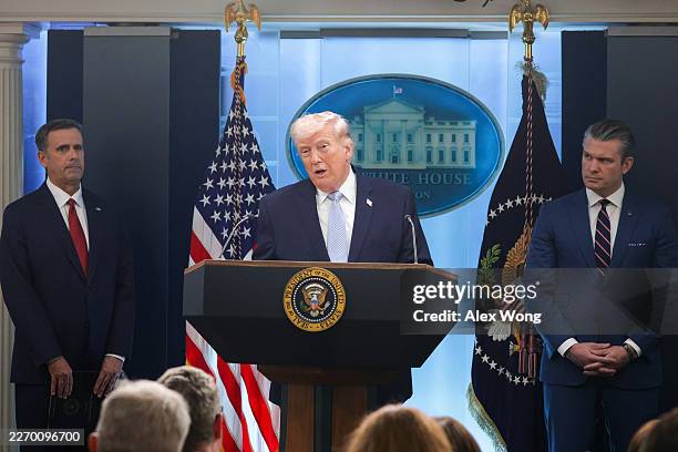 President Donald Trump speaks alongside Central Intelligence Agency Director John Ratcliffe and U.S. Secretary of War Pete Hegseth during a news...