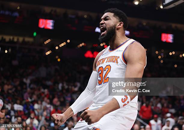 Karl-Anthony Towns of the New York Knicks dunks against Dyson Daniels and Gabe Vincent of the Atlanta Hawks during the first quarter at State Farm...