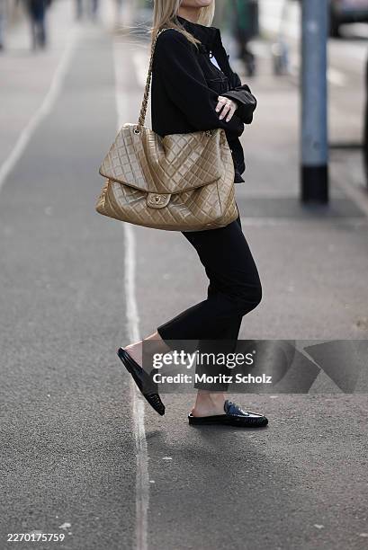 Romina Meier is seen wearing a black military inspired jacket with a cropped length, decorative frog closures and a structured silhouette; layered...