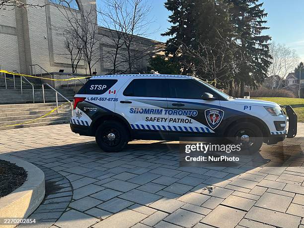 Shomrim Toronto Jewish Safety Patrol vehicle is parked under police tape outside the Beth Avraham Yoseph of Toronto synagogue following gunshots...
