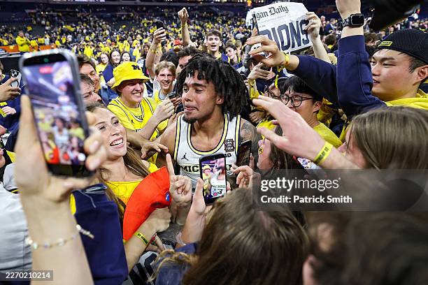 Elliot Cadeau of the Michigan Wolverines celebrates with fans after defeating the UConn Huskies, 69-63, in the National Championship of the 2026 NCAA...