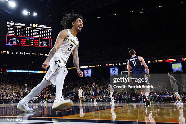 Aday Mara of the Michigan Wolverines and Tarris Reed Jr. #5 of the UConn Huskies tip-off in the National Championship of the 2026 NCAA Men's...