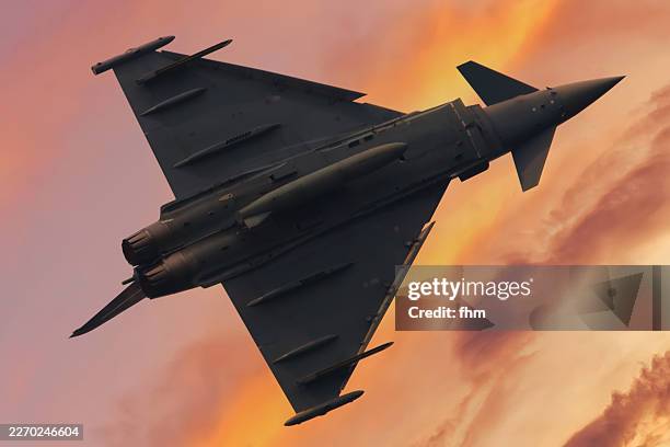 fighter aircraft eurofighter typhoon in the sunset sky - military airplane stock pictures, royalty-free photos & images