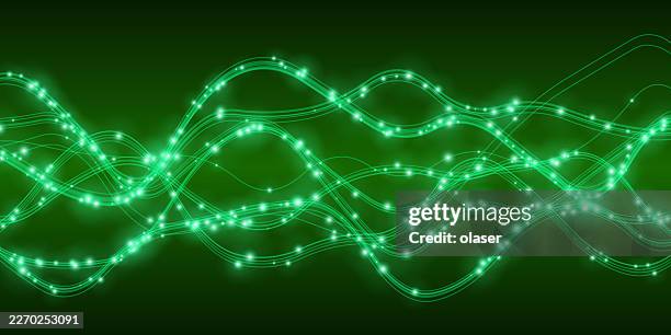 glowing green light trails wave across a dark background, forming layered curves with bright points and smooth flowing motion. - fiber optic light stock illustrations