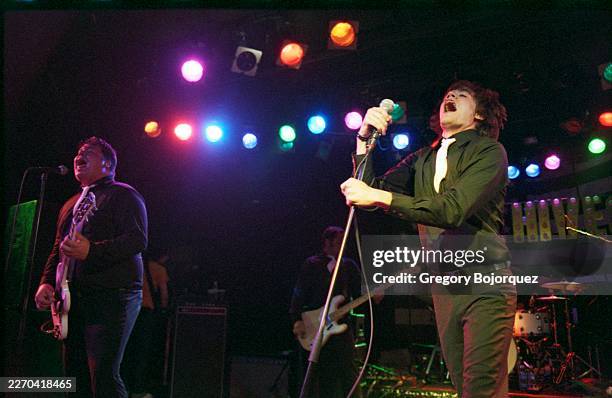 Swedish musician Vigilante Carlstroem and Swedish singer Howlin' Pelle Almquist performing with Swedish garage rock band The Hives in May, 2002 in...