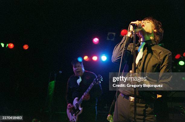Swedish musician Vigilante Carlstroem and Swedish singer Howlin' Pelle Almquist performing with Swedish garage rock band The Hives in May, 2002 in...
