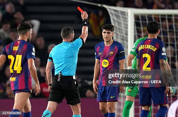 Referee Istvan Kovacs shows a red card to Pau Cubarsi of FC Barcelona following a VAR review after a challenge on Giuliano Simeone of Atletico de...