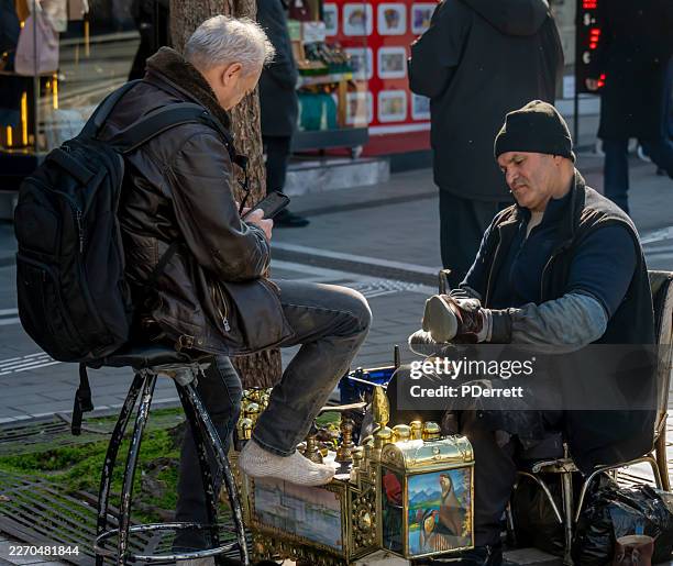 shoe polisher at work in an istanbul street. - shoe polish stock pictures, royalty-free photos & images
