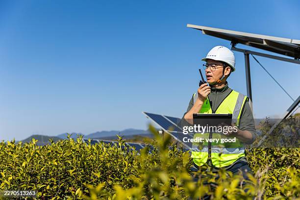 engineer working on digital tablet at solar power station - cbs stock pictures, royalty-free photos & images