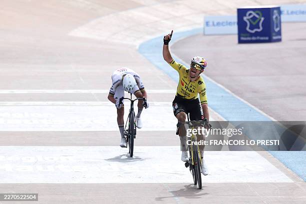 Team Visma - Lease a Bike's Belgian rider Wout van Aert celebrates victory ahead of UAE Team Emirates XRG's Slovenian rider Tadej Pogacar as he...
