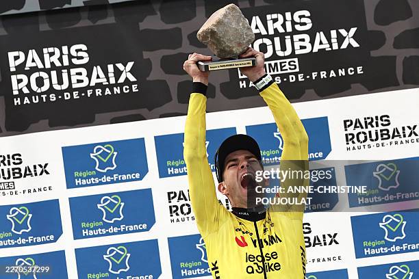 Winner Team Visma - Lease a Bike's Belgian rider Wout van Aert celebrates on the podium of the 123rd edition of the Paris-Roubaix one-day classic...