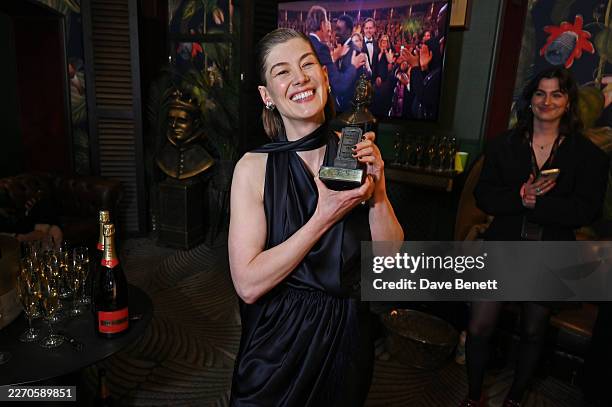 Rosamund Pike, winner of the Best Actress award for "Inter Alia", poses backstage at The Olivier Awards 2026, celebrating their 50th anniversary, at...