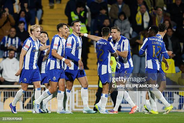 Porto's Polish defender Jan Bednarek and teammates celebrate Estoril's Portuguese midfielder Xeka's own goal during the Portuguese League football...