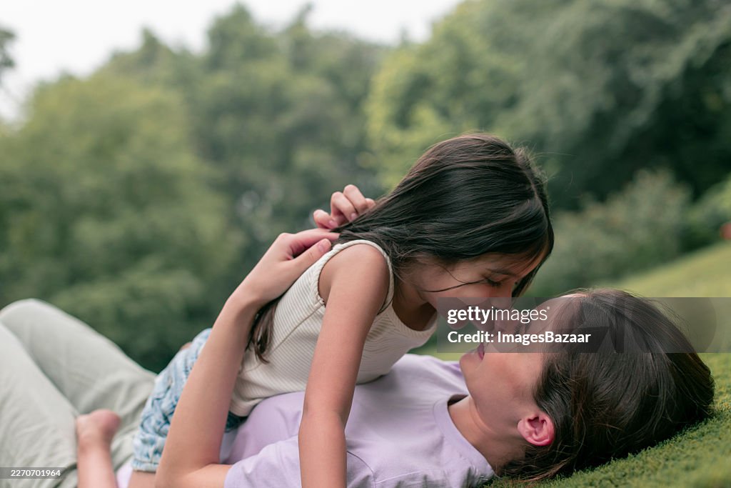 Mother and daughter having fun in park