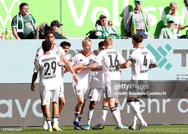 Oscar Hojlund of Eintracht Frankfurt celebrates scoring his team's first goal with teammates during the Bundesliga match between VfL Wolfsburg and...