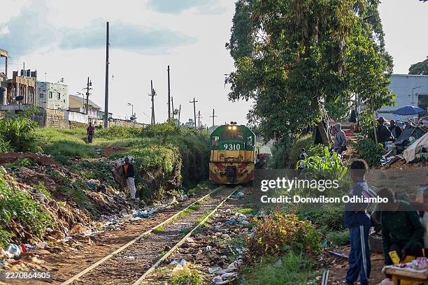 Luggage train runs through Kibera Railway line on April 14, 2026 in Nairobi, Kenya. Kibera is the largest slum in Africa and one of the biggest in...