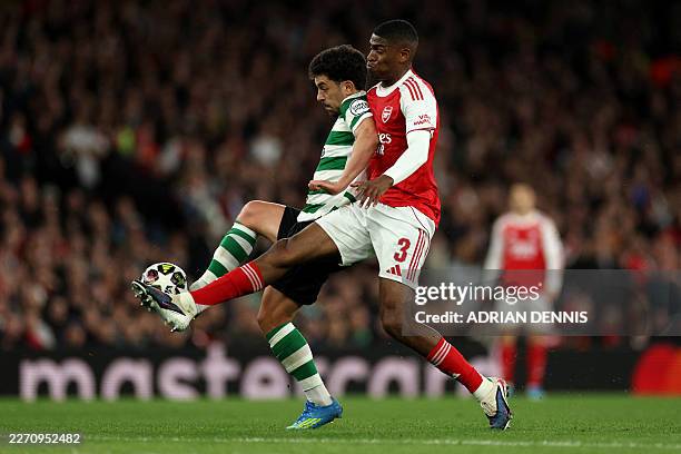 Sporting Lisbon's Portuguese striker Pedro Goncalves is put under pressure by Arsenal's Spanish defender Christhian Mosquera during the UEFA...