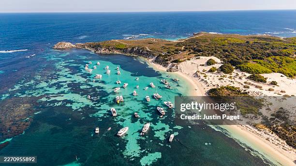 an aerial/drone view onto boats moored up by rottnest island, western australia - rottnest island stock pictures, royalty-free photos & images