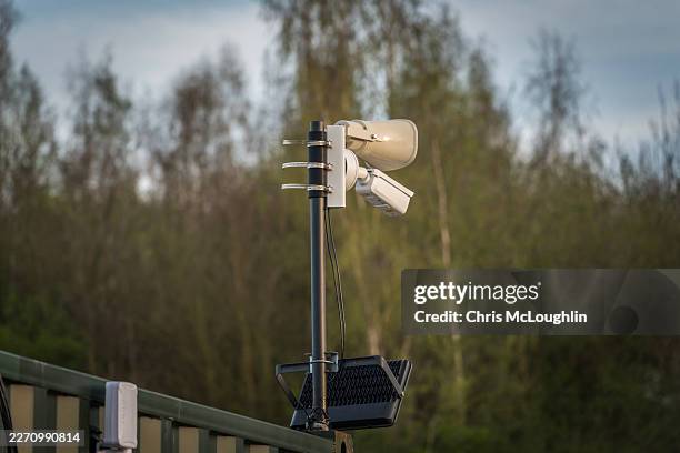 advanced outdoor security solution with cctv camera, loudspeaker, and floodlight system - motion detector stock pictures, royalty-free photos & images