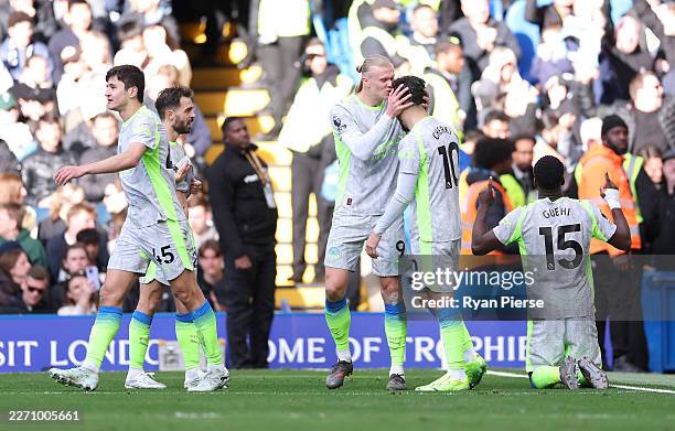 Marc Guehi of Manchester City celebrates scoring his team's second goal alongside Erling Haaland and Rayan Cherki during the Premier League match...
