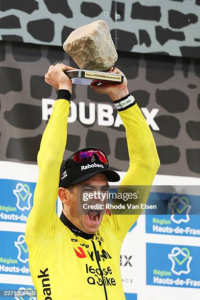 Wout van Aert of Belgium and Team Visma | Lease a Bike celebrates at podium as race winner with the Cobblestone Trophy during the 123rd Paris-Roubaix...