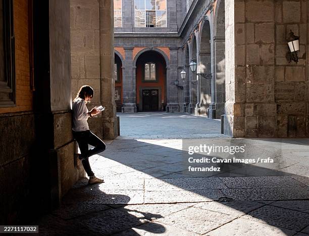 tourist woman reading guide book in city - guidebook stock pictures, royalty-free photos & images