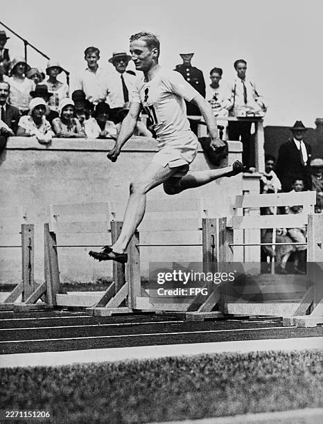 English athlete and peer Lord Burghley, David Cecil, 6th Marquess of Exeter, representing England during the 440 yards hurdles event at the 1930...