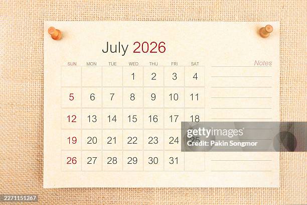 desk calendar 2026: july card calendar is used to plan daily work and life with a push pin on burlap background. - july stock pictures, royalty-free photos & images