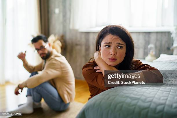 unhappy couple having relationship problems in bedroom - relationship breakup stock pictures, royalty-free photos & images