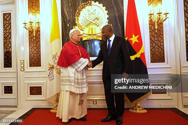 Pope Leo XIV shakes hands with Angola's President Joao Lourenco during their meeting at the Presidential Palace in Luanda on the sixth day of an...