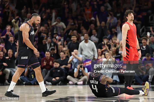 Jalen Green of the Phoenix Suns reacts alongside Dillon Brooks after Green made a three-point shot against the Portland Trail Blazers during the...