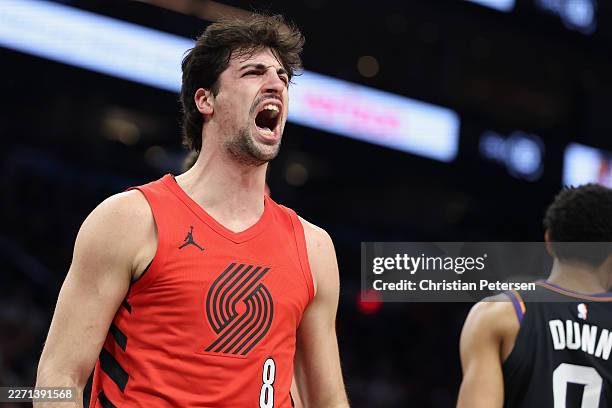 Deni Avdija of the Portland Trail Blazers reacts after scoring and drawing a foul against the Phoenix Suns during the first half of an NBA play-in...