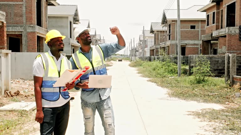 https://media.gettyimages.com/id/2271431923/video/two-construction-professionals-in-hard-hats-review-blueprints-on-a-suburban-housing-site.jpg?b=1&s=640x640&k=20&c=pKfxwruO6OzrRoD4BQfAtIbkzQjcP3ioNuQm09nlMXU=